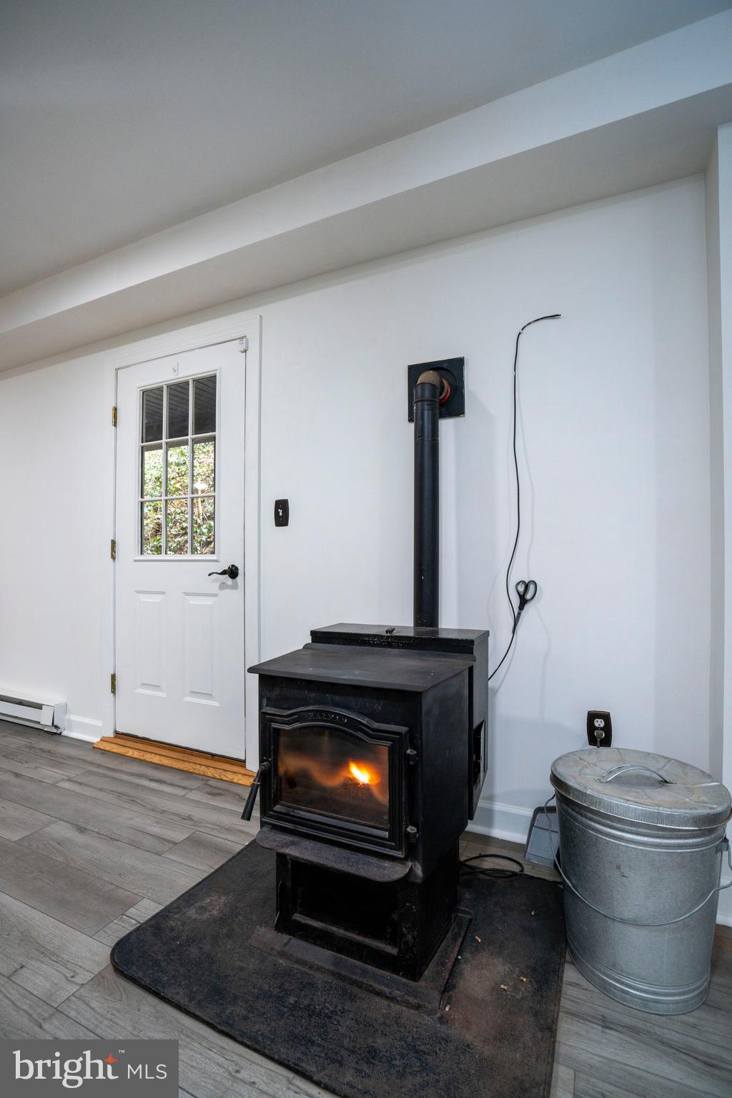 874 Spring Creek Road Bellefonte, PA 16823 - Photo 11 of 45 a living room with a fireplace and a wooden floor