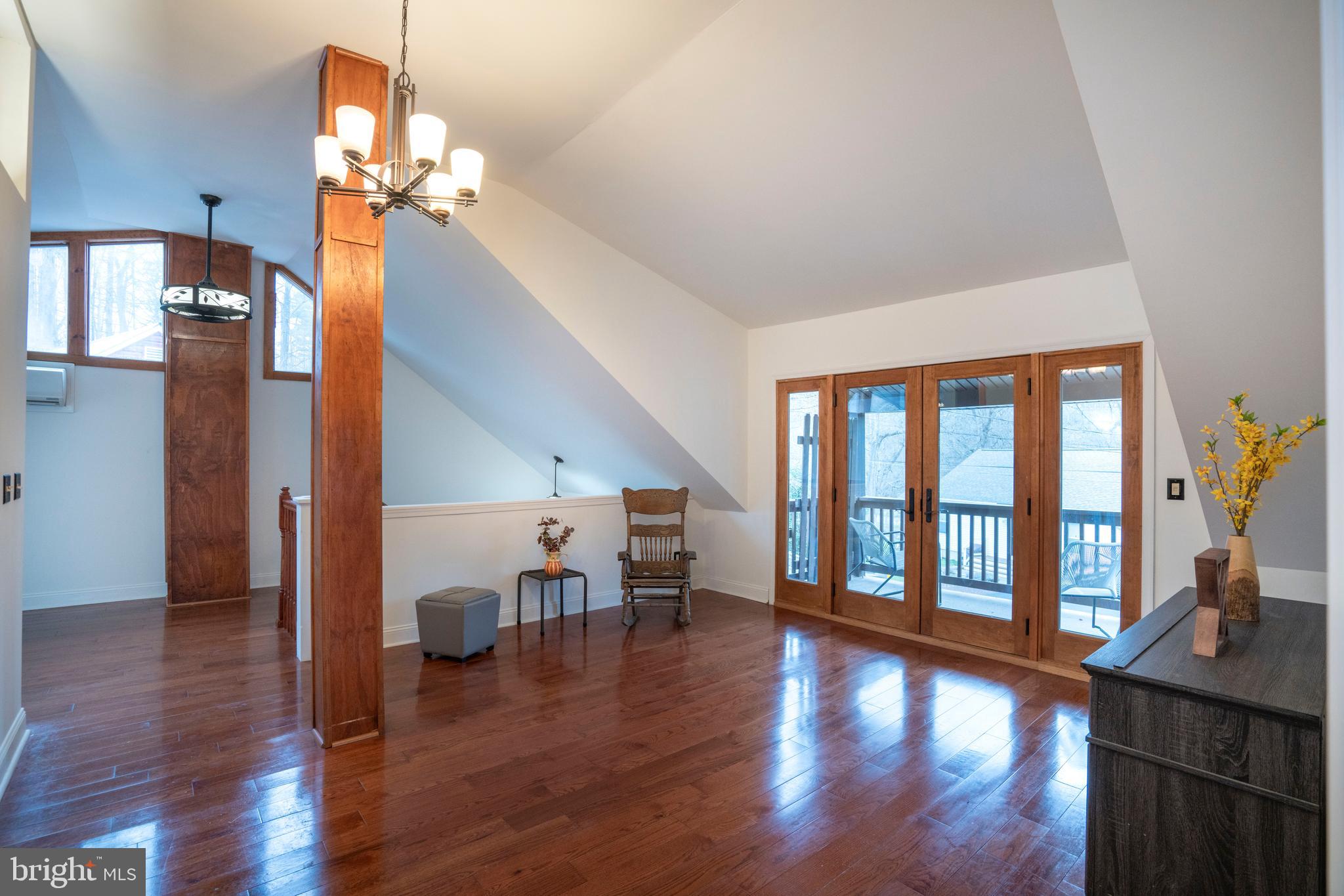 874 Spring Creek Road Bellefonte, PA 16823 - Photo 26 of 45 a view of a livingroom with furniture wooden floor a chandelier