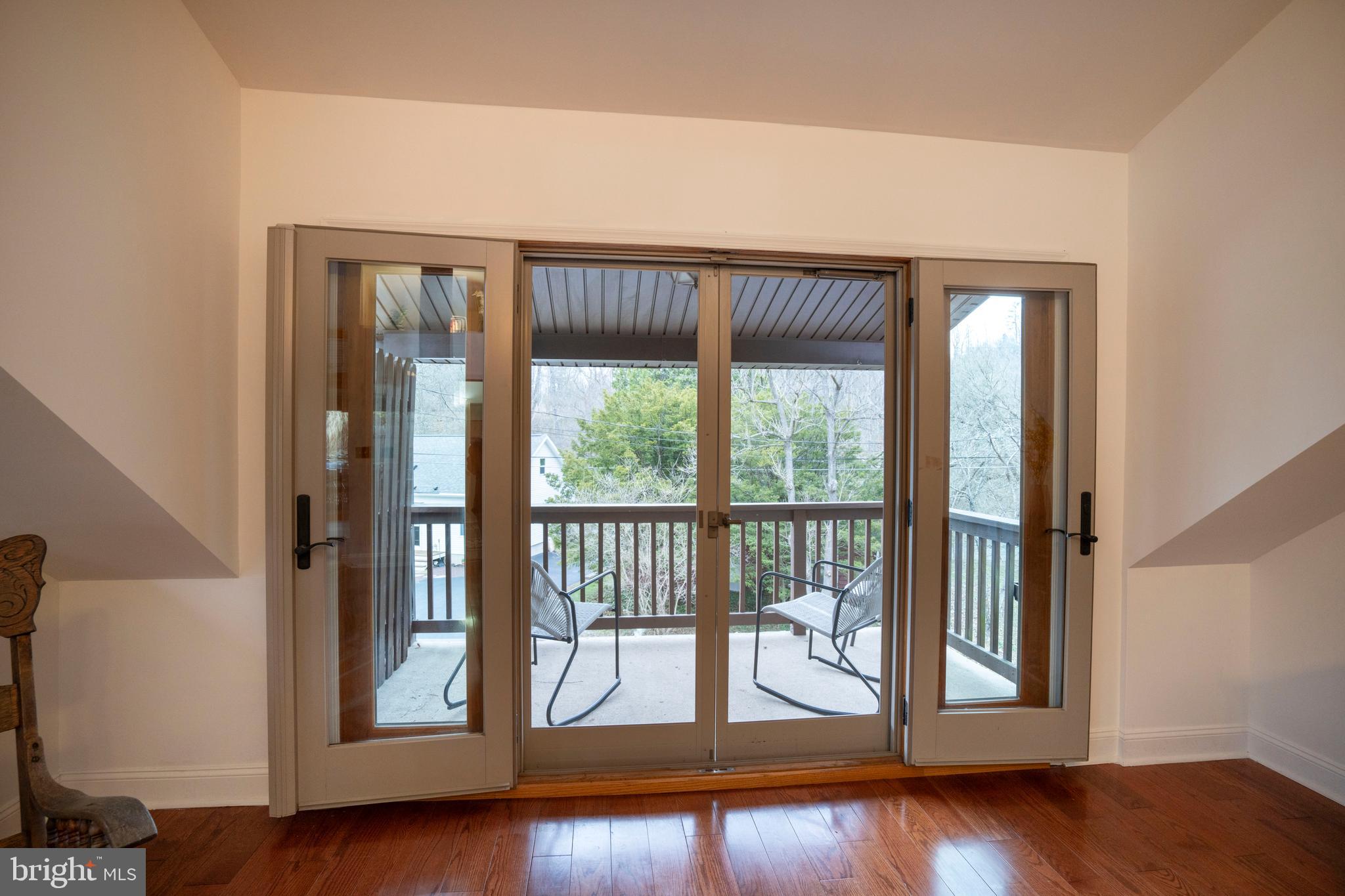 874 Spring Creek Road Bellefonte, PA 16823 - Photo 27 of 45 an empty room with wooden floor and windows