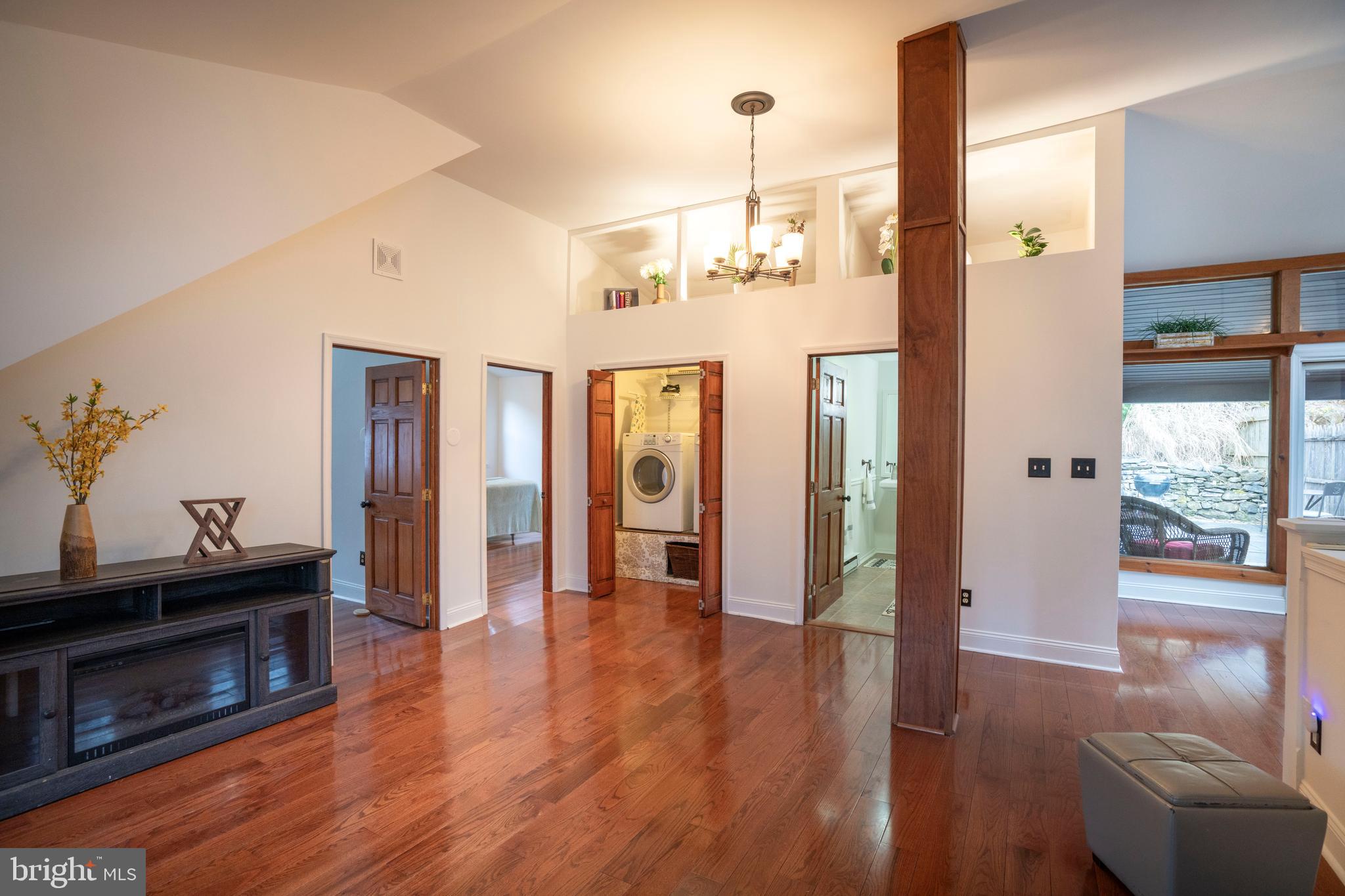 874 Spring Creek Road Bellefonte, PA 16823 - Photo 29 of 45 a view of a hallway with wooden floor and chandelier