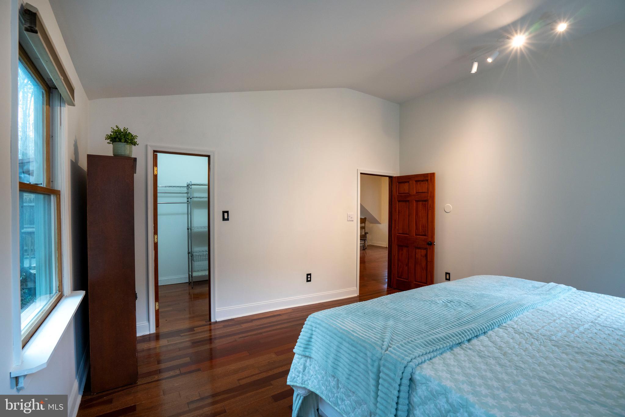 874 Spring Creek Road Bellefonte, PA 16823 - Photo 34 of 45 a bedroom with a bed and wooden floor