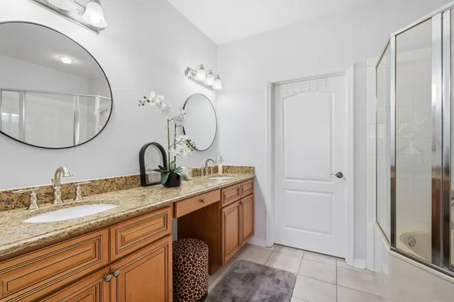 a bathroom with a granite countertop sink mirror and vanity