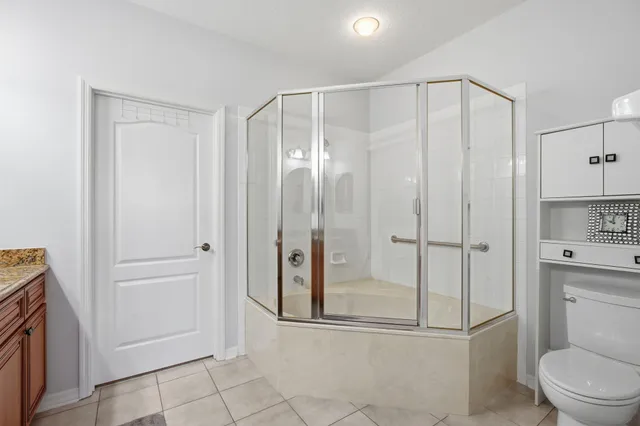 a bathroom with a shower a toilet and sink