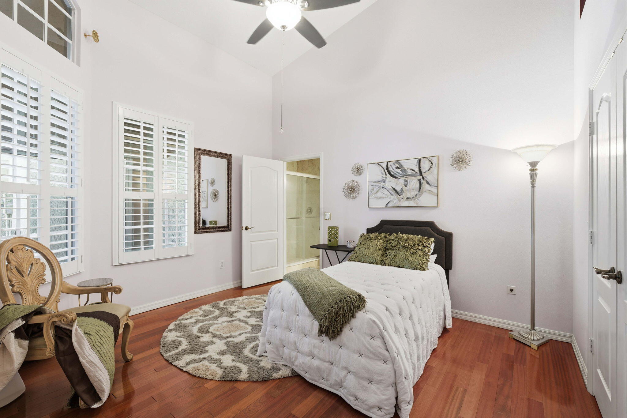 1632 Southwest Harbour Isles Circle, Unit 88 Port St. Lucie, FL 34986 - Photo 19 of 36 a bedroom with a bed and wooden floor