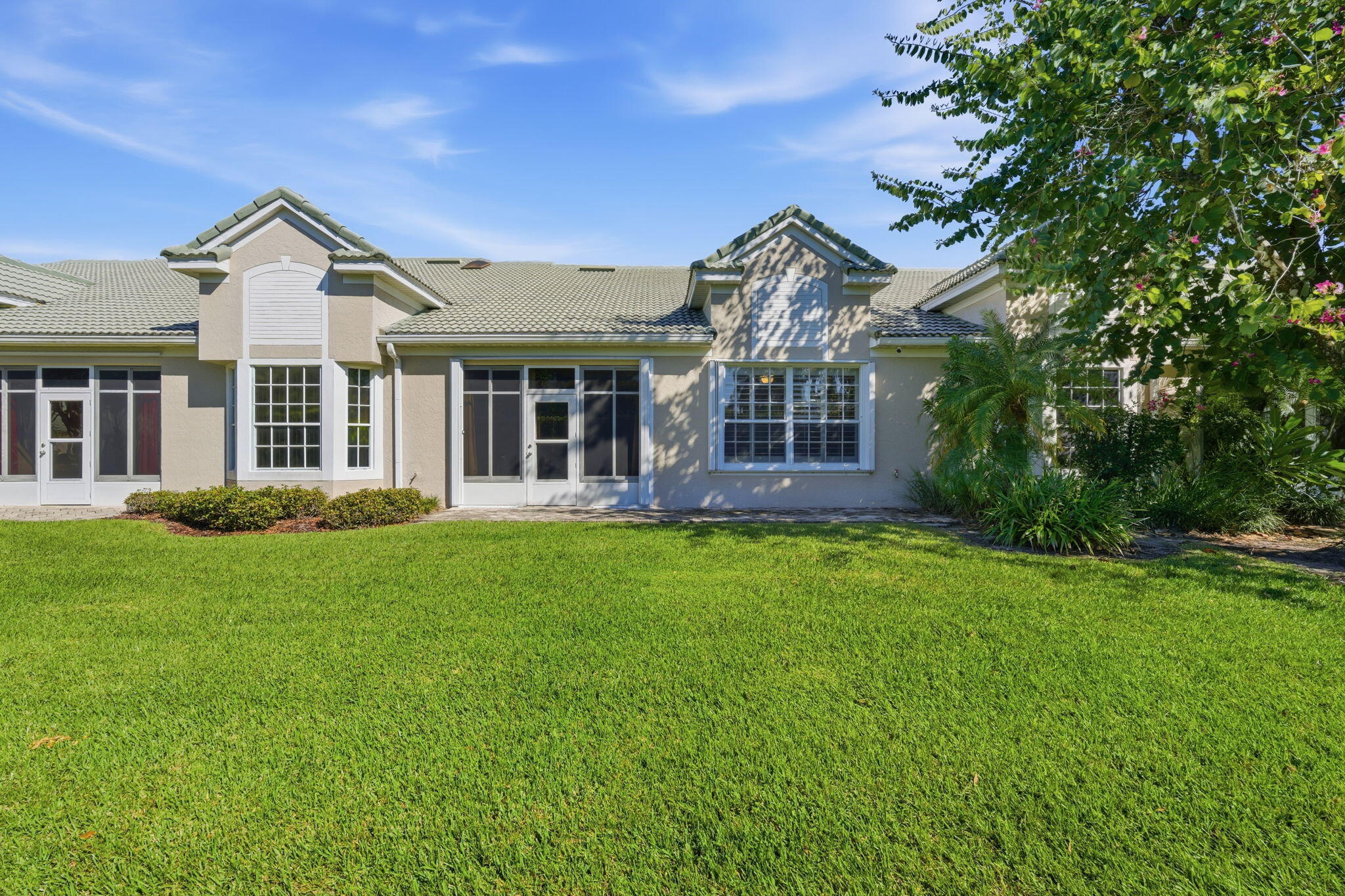 1632 Southwest Harbour Isles Circle, Unit 88 Port St. Lucie, FL 34986 - Photo 25 of 36 a front view of a house with a garden