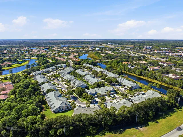 an aerial view of multiple houses with yard