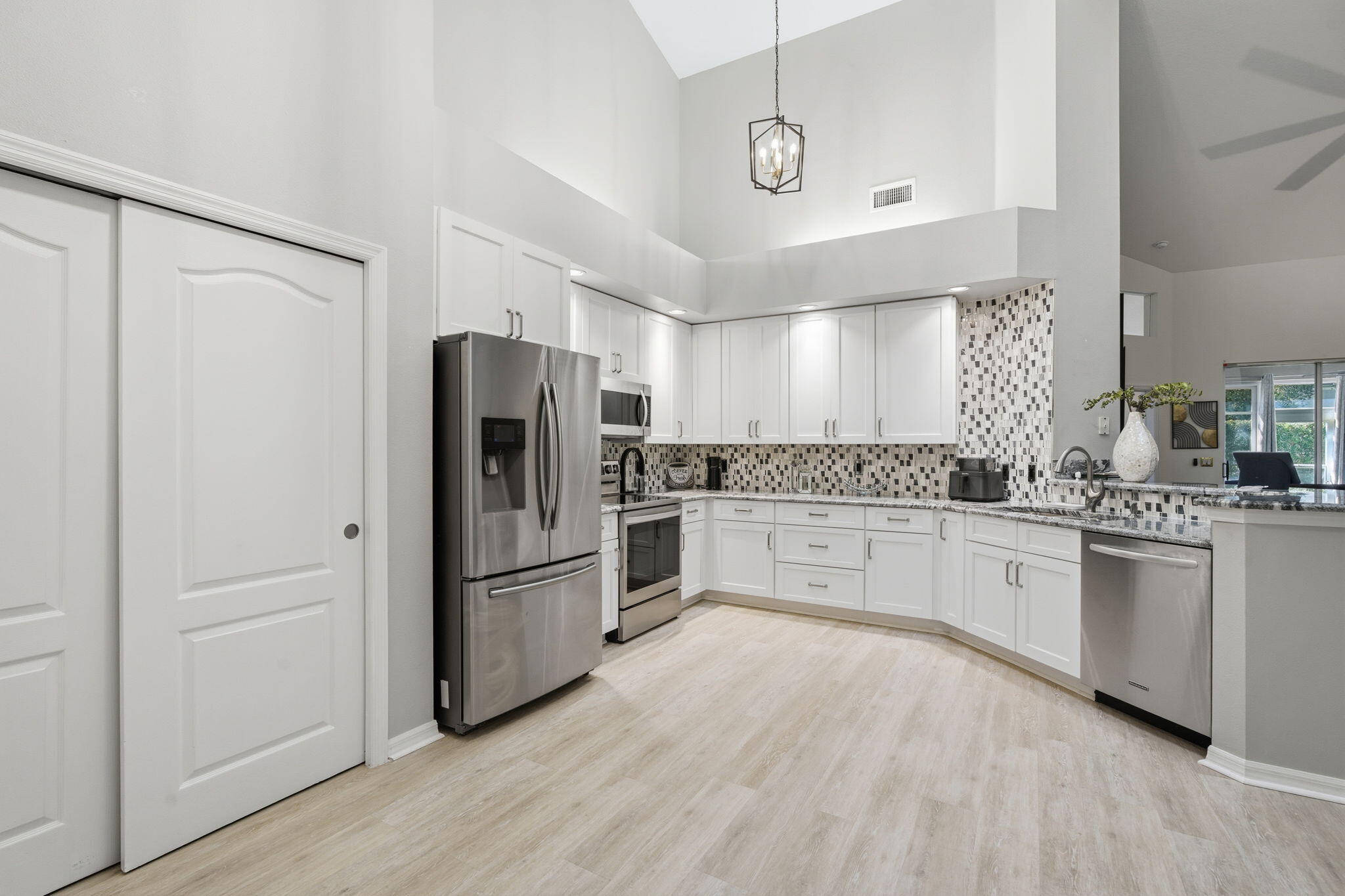 1632 Southwest Harbour Isles Circle, Unit 88 Port St. Lucie, FL 34986 - Photo 10 of 36 a kitchen with granite countertop stainless steel appliances a refrigerator and cabinets