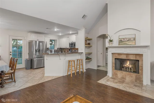 a open kitchen with white cabinets and stainless steel appliances