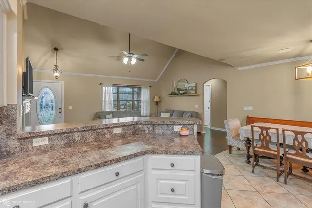 a kitchen with cabinets and window