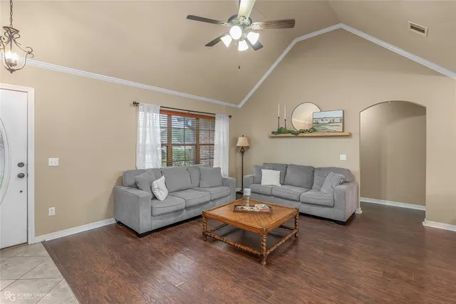a living room with furniture and a wooden floor