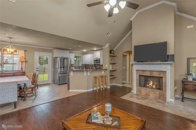 a living room with furniture a fireplace and a flat screen tv