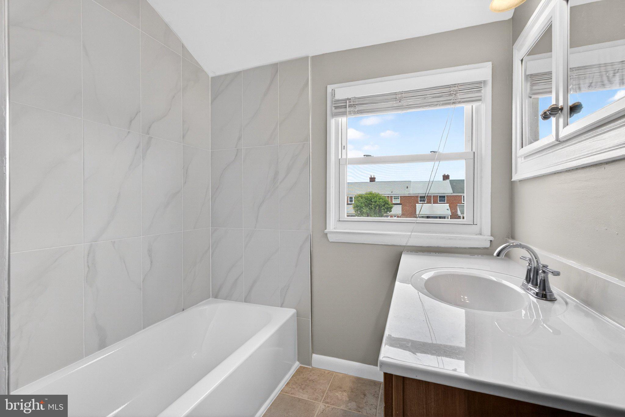 7729 Charlesmont Road Baltimore, MD 21222 - Photo 27 of 38 Modern bathroom with natural light.