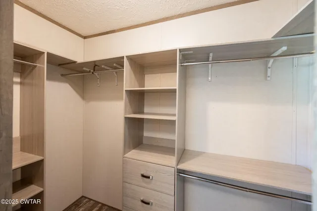 a bathroom with a walk in closet and mirror
