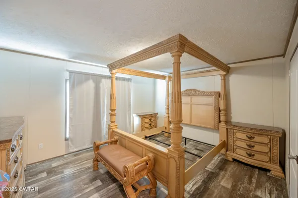 a bedroom with furniture and large window