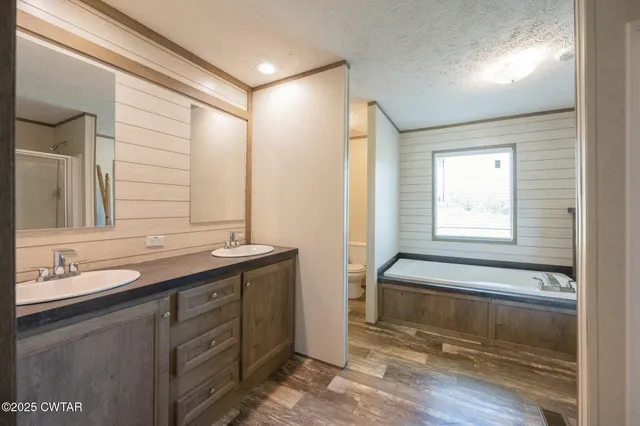 a bathroom with a double vanity sink and a bathtub