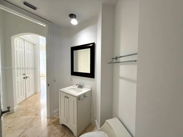 a view of kitchen with refrigerator and window