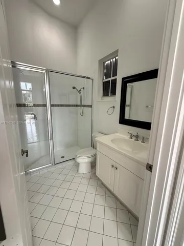 a large kitchen with kitchen island a large counter top stainless steel appliances and cabinets