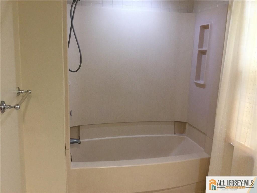 2803 Ridgefield Court Helmetta, NJ 08828 - Photo 11 of 20 a bathroom with a bath tub with a shower