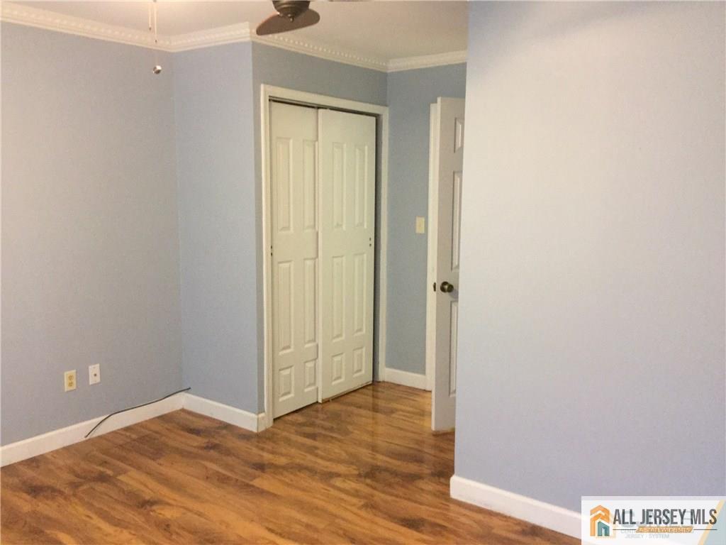 2803 Ridgefield Court Helmetta, NJ 08828 - Photo 12 of 20 a view of an empty room with wooden floor