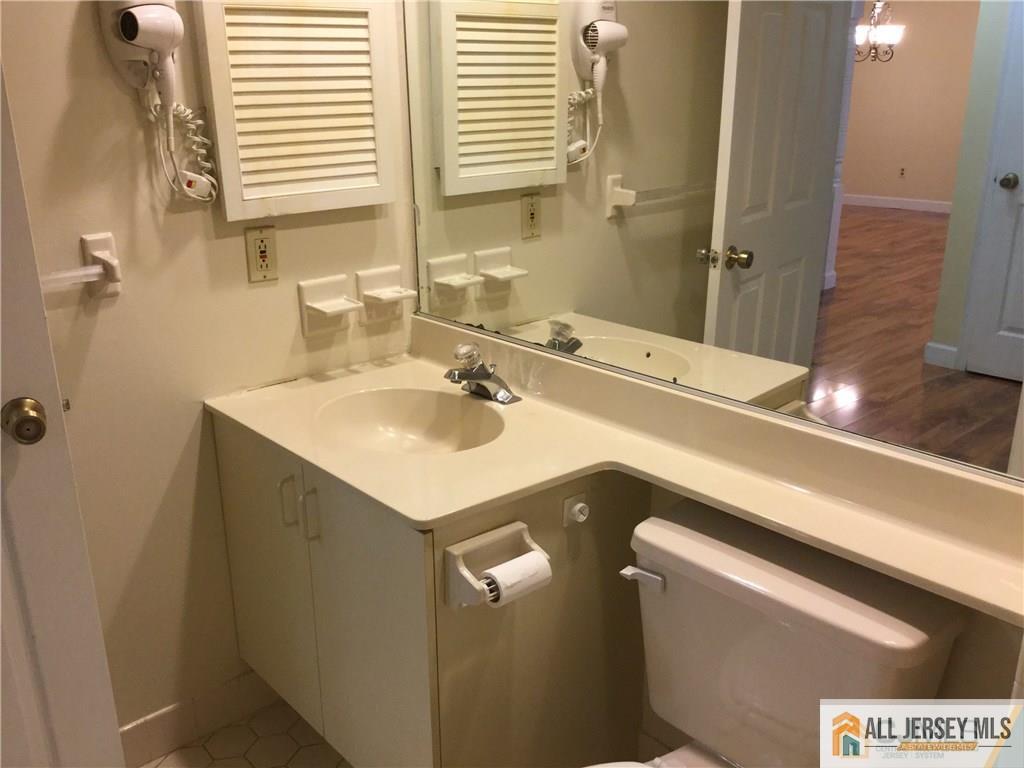 2803 Ridgefield Court Helmetta, NJ 08828 - Photo 13 of 20 a bathroom with a sink and a mirror