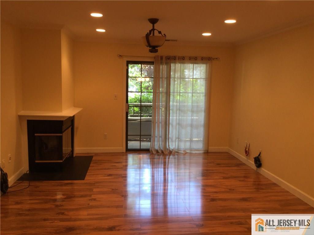 2803 Ridgefield Court Helmetta, NJ 08828 - Photo 16 of 20 a view of an empty room with wooden floor and a window
