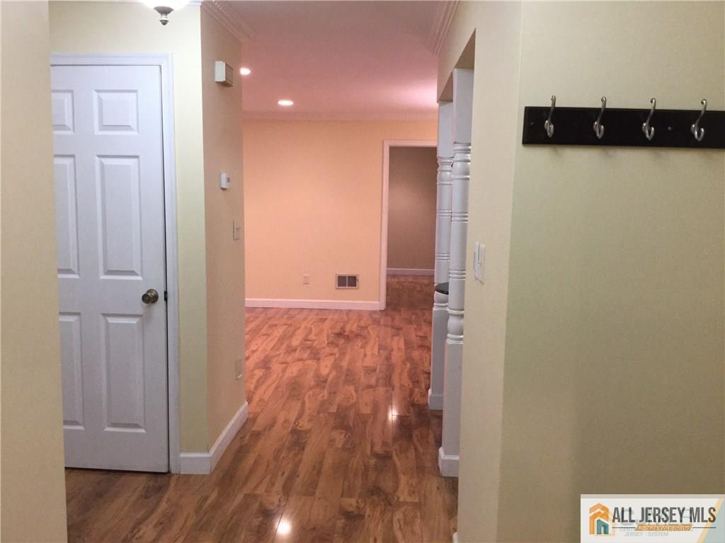 2803 Ridgefield Court Helmetta, NJ 08828 - Photo 2 of 20 a view of a hallway with wooden floor