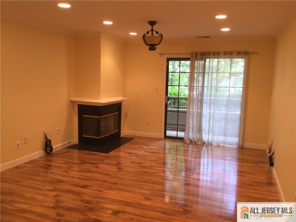 2803 Ridgefield Court Helmetta, NJ 08828 - Photo 3 of 20 a view of an empty room with a window and wooden floor