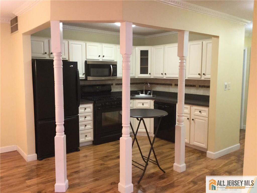 2803 Ridgefield Court Helmetta, NJ 08828 - Photo 8 of 20 a kitchen with stainless steel appliances a refrigerator and a stove top oven