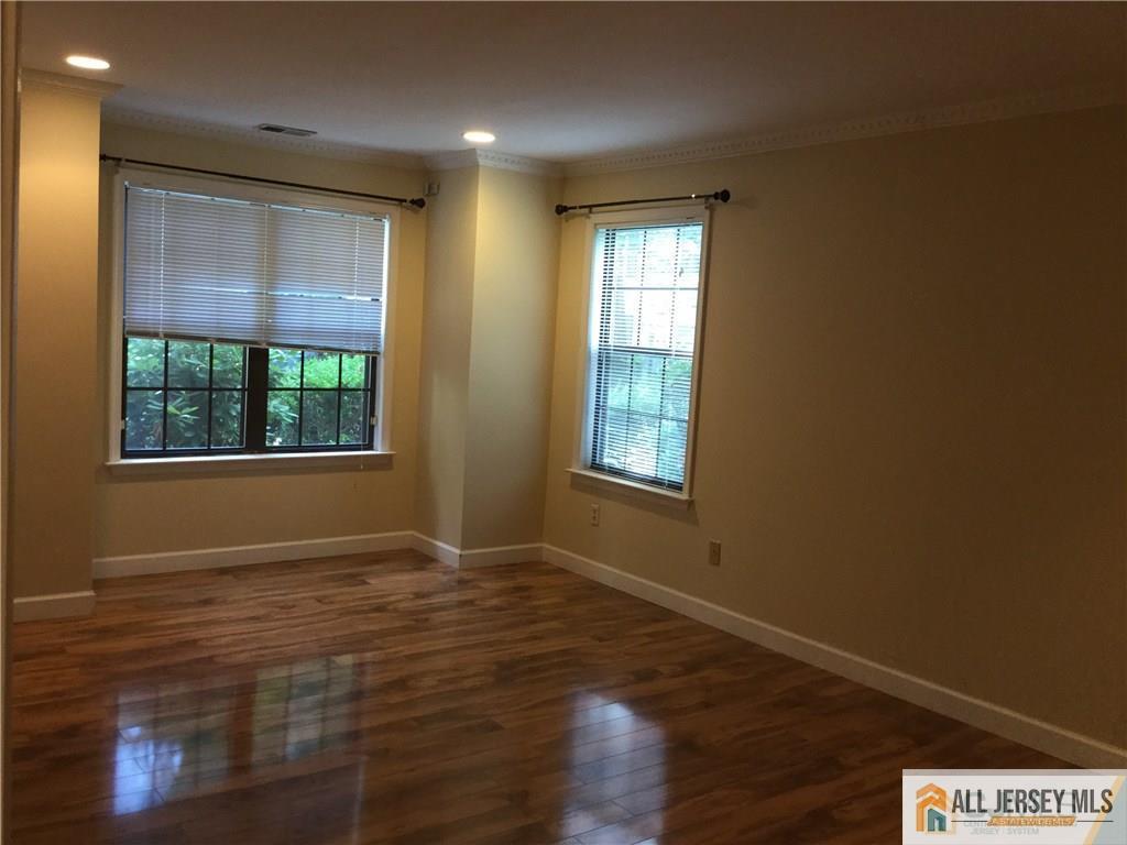 2803 Ridgefield Court Helmetta, NJ 08828 - Photo 9 of 20 an empty room with wooden floor and windows