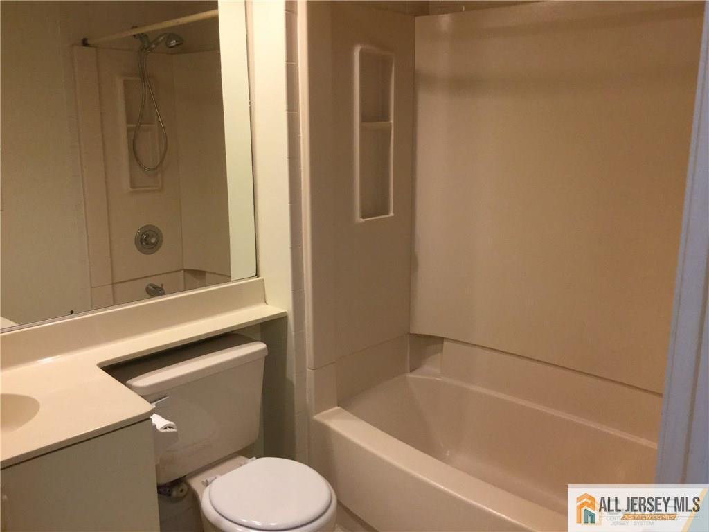 2803 Ridgefield Court Helmetta, NJ 08828 - Photo 10 of 20 a bathroom with a sink a toilet and shower