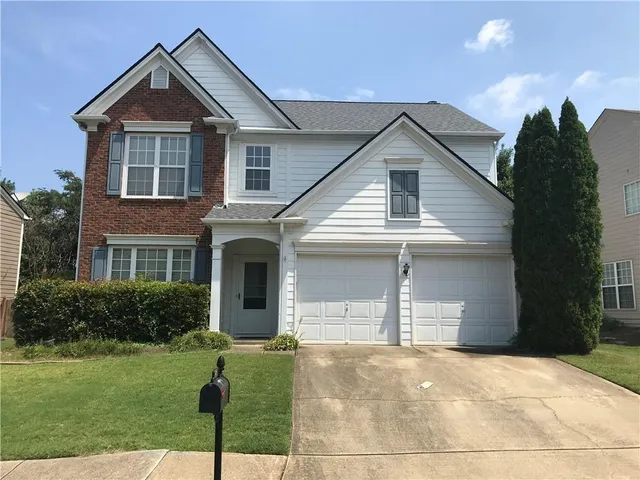a view of a yard in front view of a house