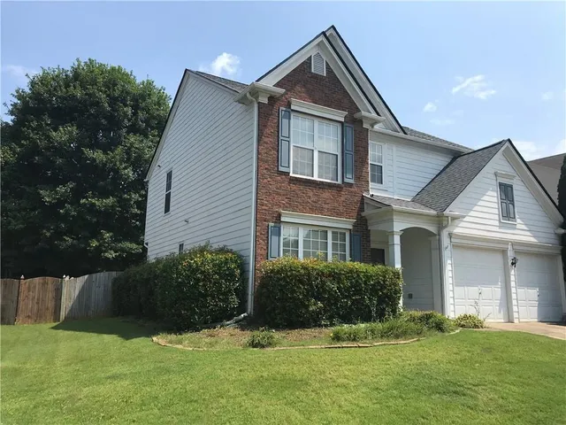a front view of a house with a yard
