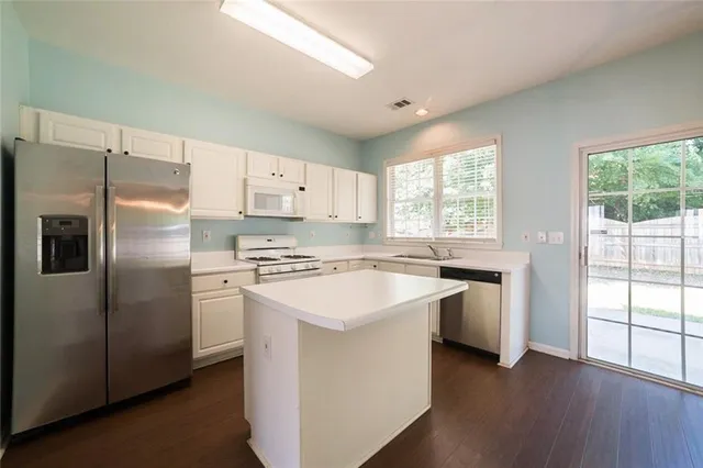 a kitchen with a stove a sink and a refrigerator