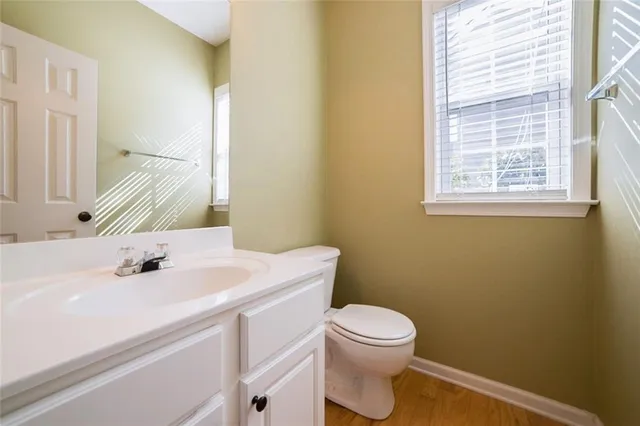 a bathroom with a sink a toilet and a mirror