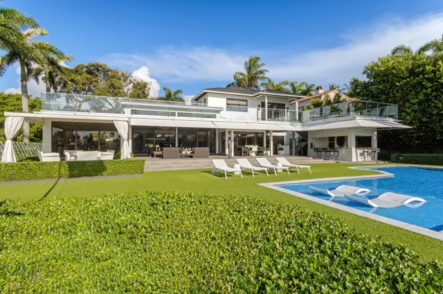a living room with furniture kitchen view and a window