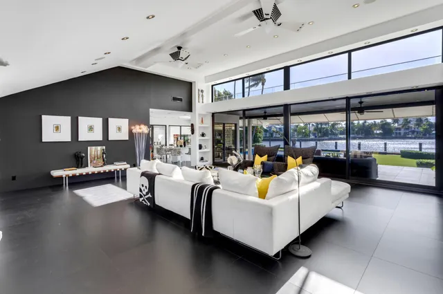 a bedroom with a bed and large windows