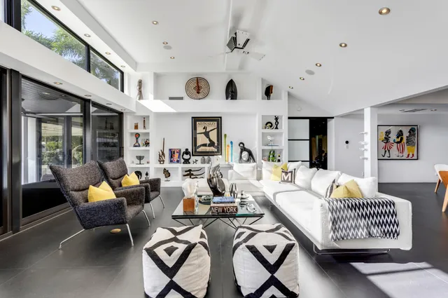 a view of a dining room with furniture large windows and wooden floor