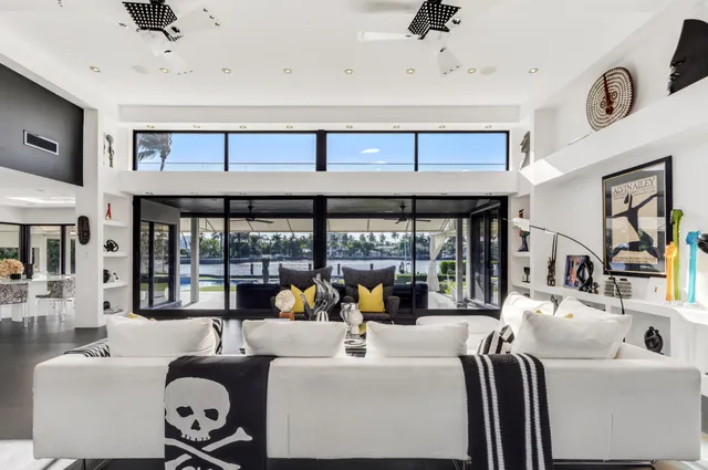 a large white kitchen with a large window