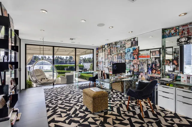 a kitchen that has a lot of white cabinets and stainless steel appliances