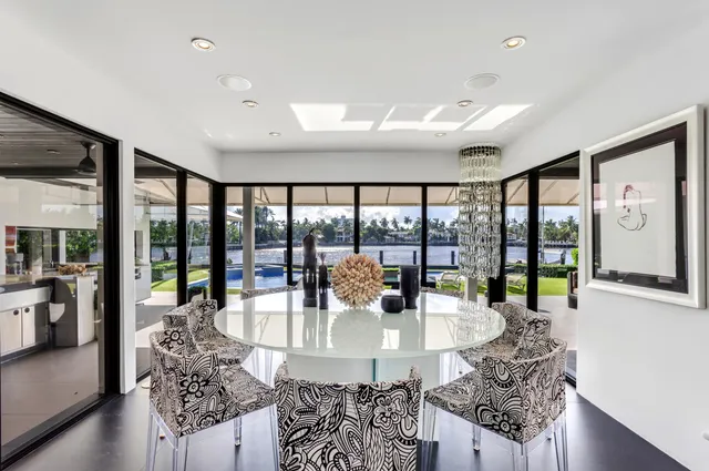 a spacious bedroom with large window and a couch