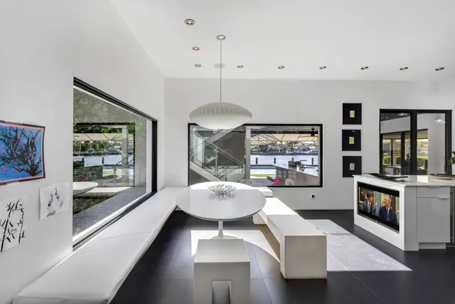 a living room with a large window and furniture