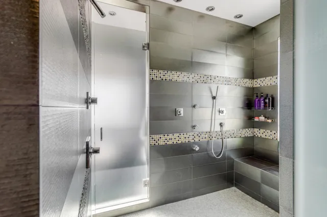 an aerial view of a houses with a yard and lake view