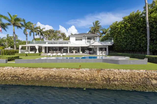 a view of a lake with couches chairs