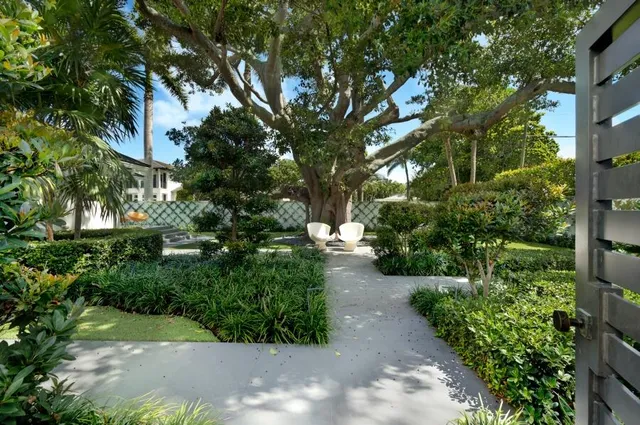a view of a livingroom with furniture wooden floor and a large window