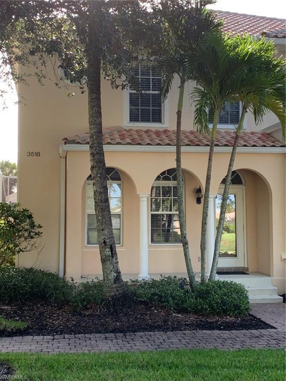 3518 Zanzibar Way Naples, FL 34119 - Photo 13 of 13 a front view of a house with garden