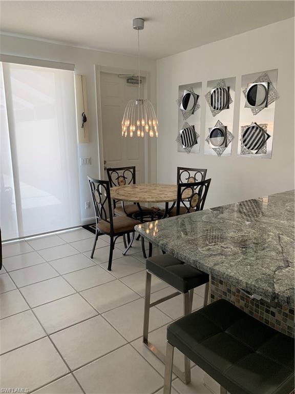 3518 Zanzibar Way Naples, FL 34119 - Photo 3 of 13 a view of a dining room with furniture