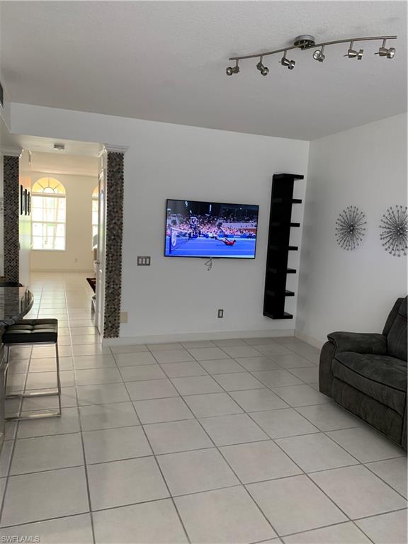 3518 Zanzibar Way Naples, FL 34119 - Photo 5 of 13 a view of livingroom with furniture and cabinet