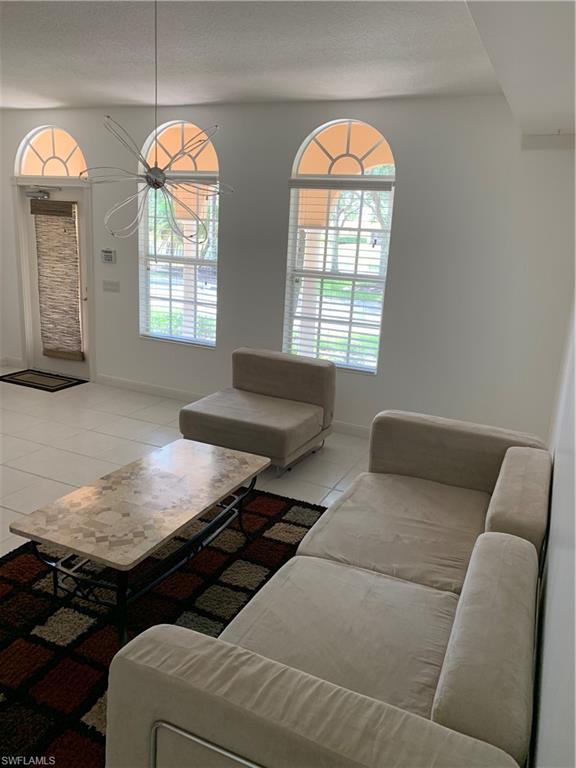3518 Zanzibar Way Naples, FL 34119 - Photo 7 of 13 a living room with furniture and a large window