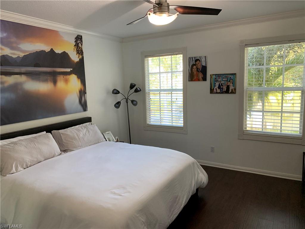 3518 Zanzibar Way Naples, FL 34119 - Photo 8 of 13 a bed sitting in a bedroom next to a window