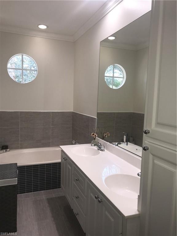 3518 Zanzibar Way Naples, FL 34119 - Photo 9 of 13 a bathroom with a sink and a mirror